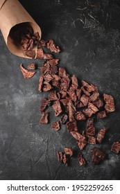 Dog Treats. Dried Pieces Of Lung On A Dark Stone Background. Helpful Treats For Pets. Flatlay, Space For Text. Jerky