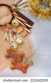 Dog Treats For A Fantastic Pet Christmas Treat. Rustic Flat-lay With Iced Dog Biscuit And Jingle Bells