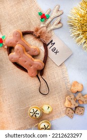 Dog Treats For A Fantastic Pet Christmas Treat. Rustic Flat-lay With Iced Dog Biscuit And Jingle Bells