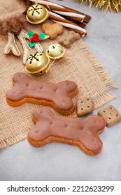 Dog Treats For A Fantastic Pet Christmas Treat. Rustic Flat-lay With Iced Dog Biscuit And Jingle Bells