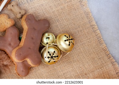 Dog Treats For A Fantastic Pet Christmas Treat. Rustic Flat-lay With Iced Dog Biscuit And Jingle Bells