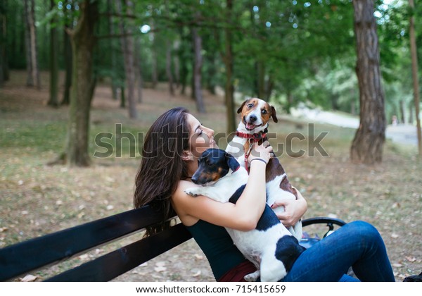 Dog walker with dogs\
enjoying in park. 