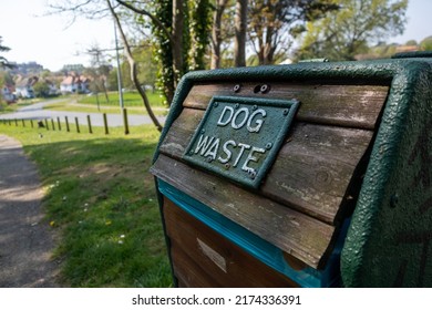 Dog waste bin on the periphery of a public parkland area - Shutterstock ID 2174336391