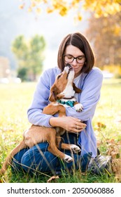 Dog And Woman Hug In Autumn Park. Girl And Cute Pet Happy Together Outdoor. Lifestyle Authentic Moment. Friendship, Love, Support, Empathy Between People And Animals