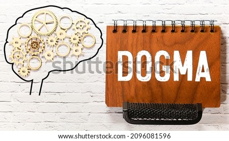 Dogma and human mind - pictured as word Dogma inside a head to symbolize relation between Dogma and the human psyche, 3d illustration