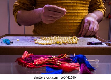 Doha, Doha/Qatar - Jan 13, 2020 : A Man wearing Brown Shirt and making praying beads 