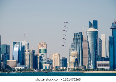 DOHA, QATAR - 18 DEC 2018: Qatar National Day Is A National Commemoration Of Qatar's Unification In 1878. It Is Celebrated Annually On 18 December. Group Of Sky Divers Flying With Their Parachutes .