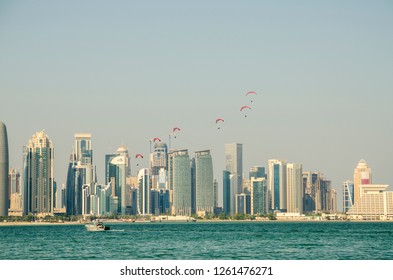 DOHA, QATAR - 18 DEC 2018: Qatar National Day Is A National Commemoration Of Qatar's Unification In 1878. It Is Celebrated Annually On 18 December. Group Of Sky Divers Flying With Their Parachutes .