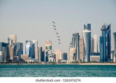 DOHA, QATAR - 18 DEC 2018: Qatar National Day Is A National Commemoration Of Qatar's Unification In 1878. It Is Celebrated Annually On 18 December. Group Of Sky Divers Flying With Their Parachutes .