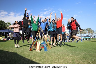 Doha, Qatar, Circa 2020: A Team Of Happy Men And Women Jumping In Joy After Winning A Boat Race. Company Staff And Colleagues From Different Various Races Met To Win. 