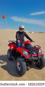 DOHA, QATAR - FEBRUARY 09 : A Man Enjoy Driving Polaris ATV At The Sealine Beach Resort