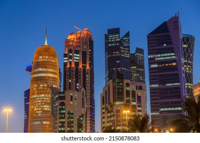 Doha, Qatar - February 22, 2022: Banks, offices and ministries and modern towers of Doha skyline reflecting in Doha Downtown. Cityscape of West Bay district.