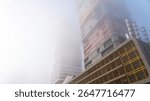 Doha, Qatar -February 24, 2025: A foggy morning in Doha with skyscrapers partially hidden in mist, creating a mysterious and serene cityscape.