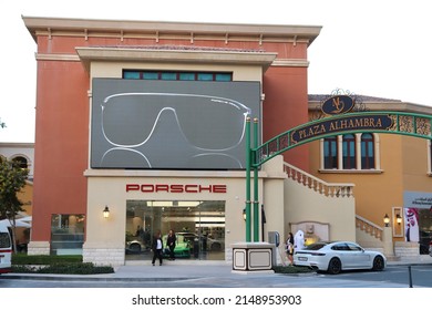 Doha, Qatar - February 6, 2019: Porsche Store Facade In The Pearl Doha. Cars, Tourists And Local Citizens With Traditional Clothes In Background. Rich Life Style.