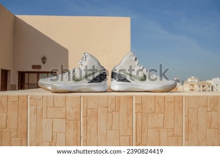 Doha, Qatar - January 1, 2017: A detailed pictue of Nike Hyperdunk Elite. A rare pair showing carbon fiber, gold and white colorway basketball shoes in VNDS condition.