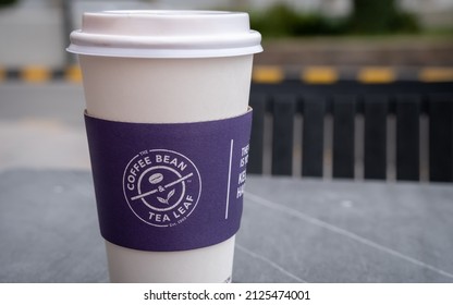 Doha, Qatar - January 16th 2022: Close Up Of A Purple The Coffee Bean And Tea Leaf Logo On A Paper Cup Sleeve