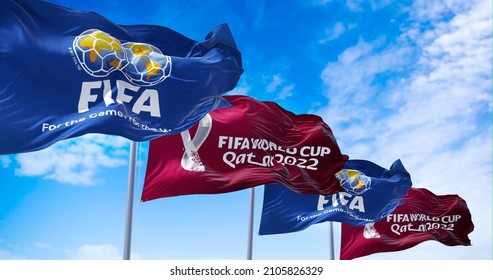 Doha, Qatar, January 2022: Flags with FIFA and Qatar 2022 World Cup logo waving in the wind. The event is scheduled in Qatar from 21 November to 18 December 2022