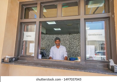 DOHA, QATAR - JULY 10; Barista Through Open Window With Discriminatory Signs For Separating  Ladies And Gentlemen To Be Served From Opposite Sides July 10 2019 Doha Qatar