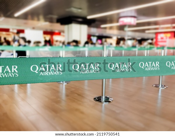 Doha, Qatar, July 2021: Green belt\
barrier with the Qatar Airways logo. Qatar Airways is the flag\
carrier airline of Qatar. Travel and airport\
security