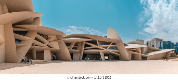 Doha, Qatar - june 2019 : A beautiful panorama of the national museum of qatar with people walking by.