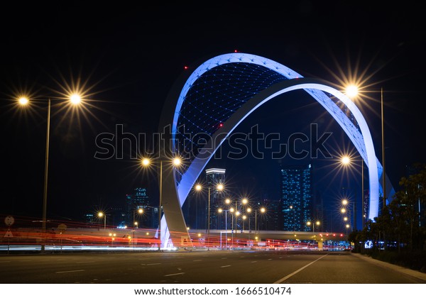 Doha, Qatar, Mar 07, 2020: Night view of well lit,\
Monument Arch Bridge (also knows and \