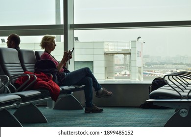 Doha, Qatar - March 29, 2016: An  European Old Lady Reading On Her IPad During Waiting At Hamad International Airport.