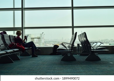 Doha, Qatar - March 29, 2016: An  European Old Lady Reading On Her IPad During Waiting At Hamad International Airport.