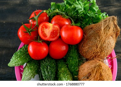 Doha, Qatar - May 02, 2020:  mix Vegetable .tomato, Quora ,karela, in basket on black wooden table 