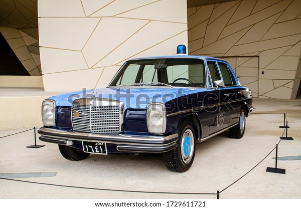 DOHA, QATAR - MAY 2020: A\
view of a vintage police car outside of Qatar National Museum,\
Doha, Qatar.