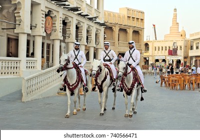 DOHA, QATAR - OCTOBER 23, 2017: Mounted police patrol the main thoroughfare of Souq Waqif market in Qatar, Arabia.