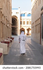 Doha, Qatar - Souq Waqif is a souq in Doha, The souq is known for selling traditional garments, spices, handicrafts, and souvenirs.
Arab Men walking in souq back view