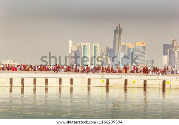 DOHA-DEC 18:\
Qataris with flags sit or stand on a vehicle during a parade to\
celebrate their National Day, on December 18, 2015 in Doha, Qatar.\
This has been an annual event since\
2009.