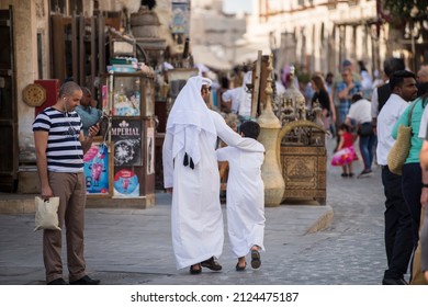 Doha,Qatar - March 05, 2019 : The Qatari Family In Traditional Attire Hang Out In Old Bazaar Market Souk Waqif.