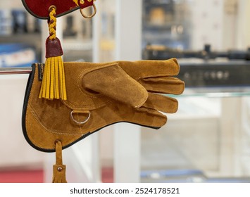 doha,qatar-September 27, 2024: A collection of falconry gloves showcased at a market stall, highlighting the craftsmanship and variety designed for handling birds of prey. - Powered by Shutterstock