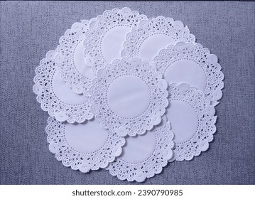 Doilies white paper on grey background. shot on top.