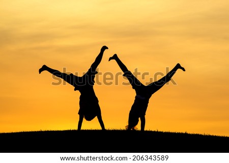 Doing cartwheels together. 