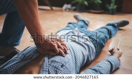 Doing CPR first aid to man with heart attack part of the resuscitation process, Close up shot with vintage picture style.