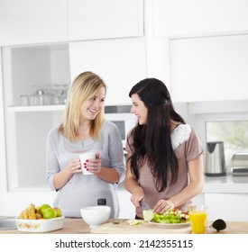 Doing a girls lunch the healthy way. Two young women making a salad in the kitchen at home. - Shutterstock ID 2142355115