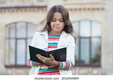 Doing Homework Isnt Fun. Small Child Do Homework Outdoors. Little Girl Write In Homework Diary. Homework Assignment. Home Schooling. Private Lesson. School And Education. Learning Environment