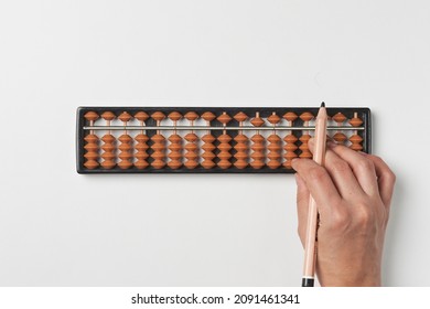 Doing mental math or mental arithmetic. Hand of person using abacus for calculating. Learning to use abacus on mental math courses