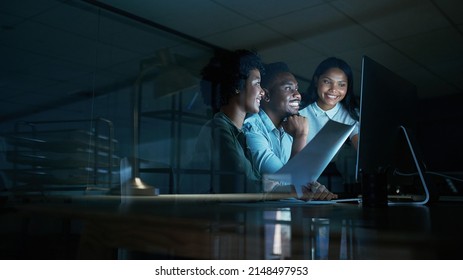 Doing what matters makes things happen. Shot of a group of young businesspeople using a computer together during a late night at work. - Powered by Shutterstock