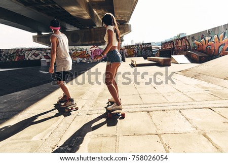 Similar – Happy young woman riding on skate with her friends