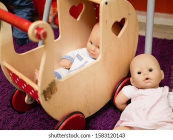 DOLL CHILD IN THE COLLECTOR. Doll In An Old-fashioned Stroller With A Quilt. Doll Toy Lying In A Pram With A Cute Little Blue And White Blanket