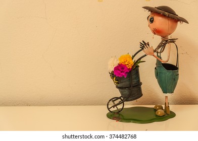 doll with flowers on the table