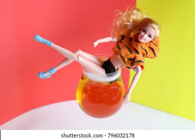 A doll with a glass. 
