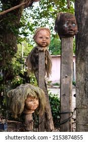 Doll heads on stakes, a sinister image. Halloween. scary photo of black magic objects. Haunted place