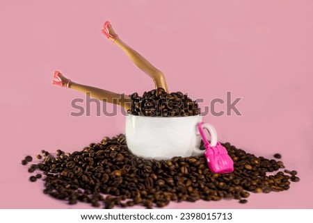 Doll legs in the coffee beans on the pink background 