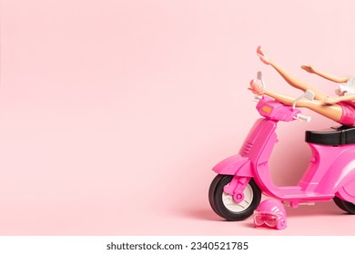 The doll rests her feet on the handlebars of a vintage scooter. Holidays, travel, vacation concept. - Powered by Shutterstock