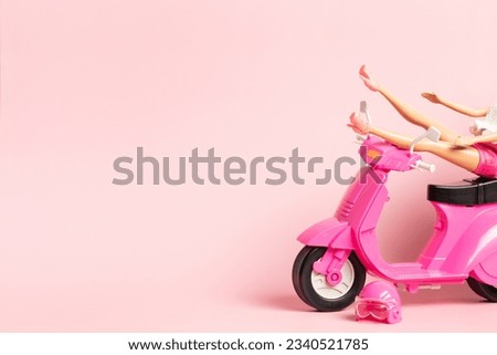 The doll rests her feet on the handlebars of a vintage scooter. Holidays, travel, vacation concept.