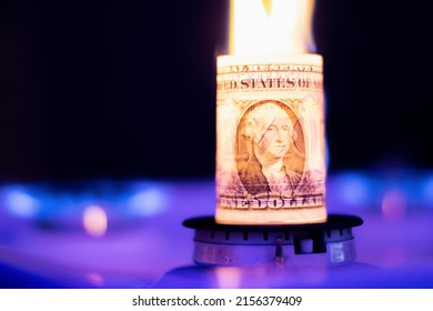 A dollar bill is burning on a gas fire, close-up. Dollar deficit
